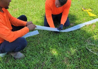 Decker Plumbing & Drains technicians in orange shirts relining a sewer
